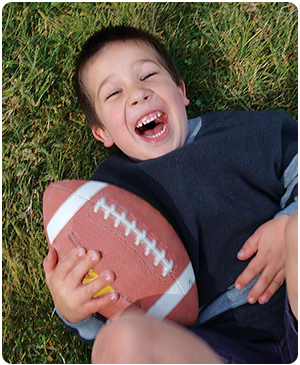 child laughing with football