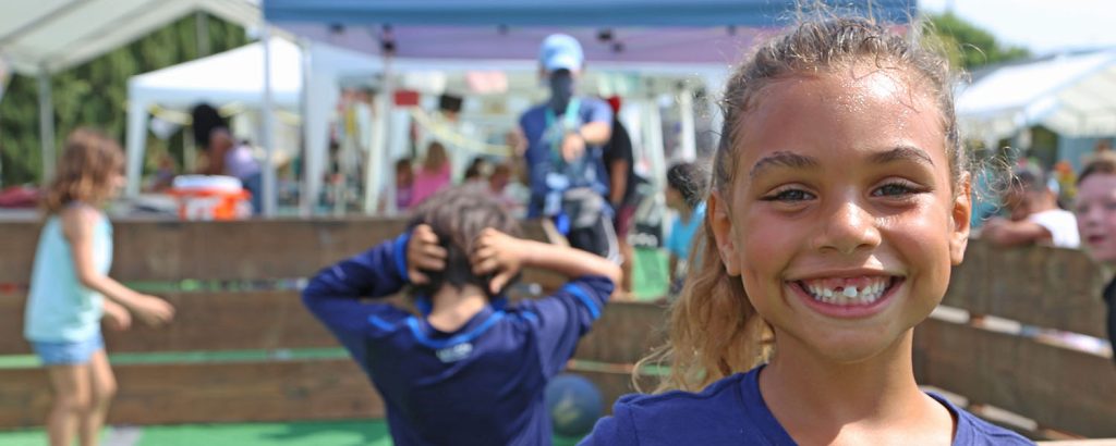 Photo of a girl smiling at a YMCA camp