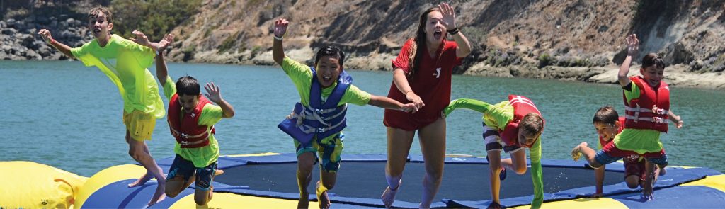 kids jumping in ocean