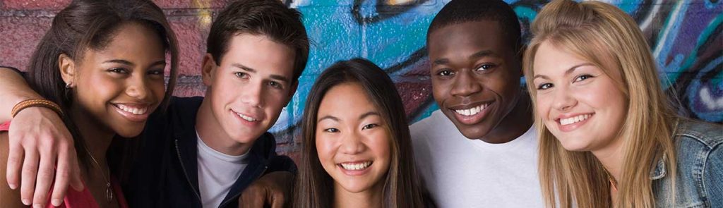 Photo of five young adults, smiling