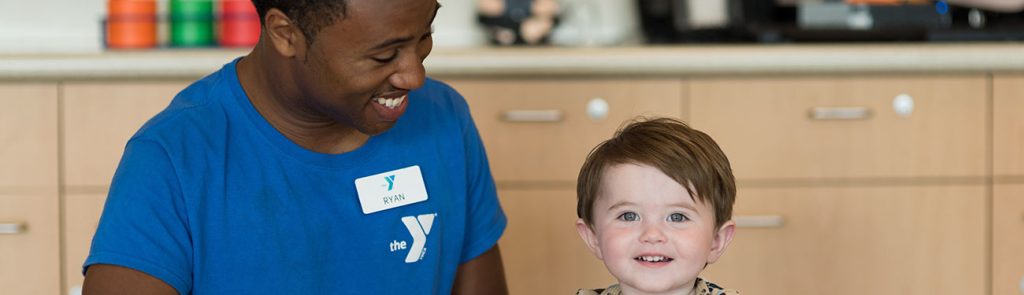 Photo of a man with a child at a child care center