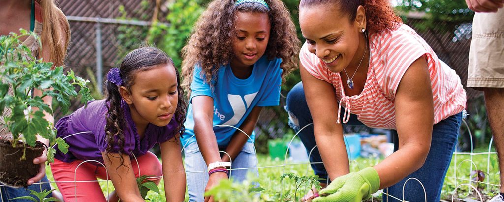 Photo of YMCA members gardening together