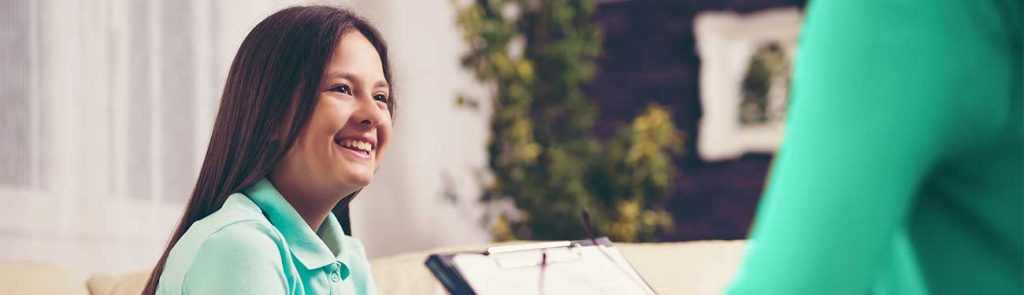 Photo of a girl with long hair, smiling