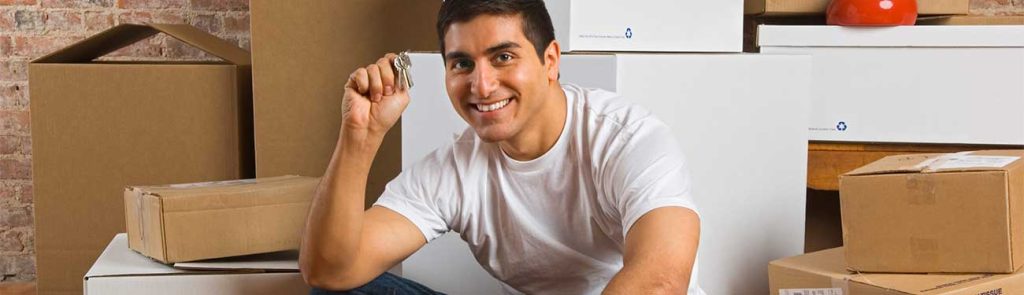 Photo of a man ready to move, sitting in front of boxes