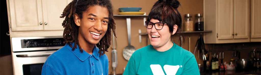 Photo of two members of the YMCA preparing food together