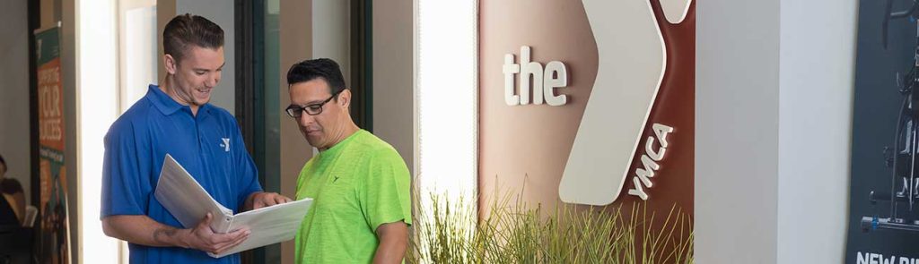 Photo of a man offering support to a YMCA member