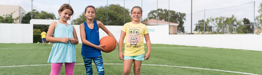 Three girls playing indoor soccer