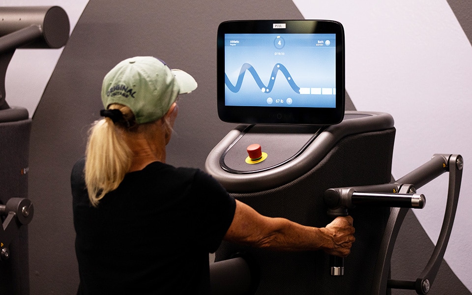 woman using egym equipment
