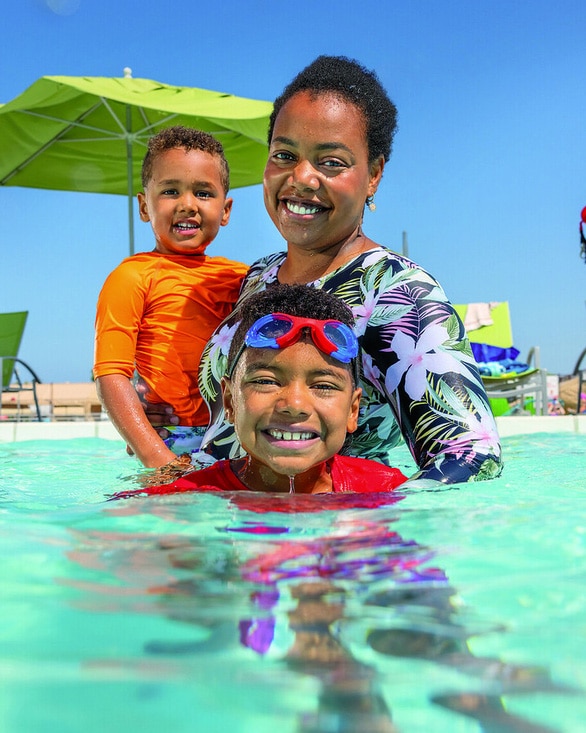 mom and two kids in pool