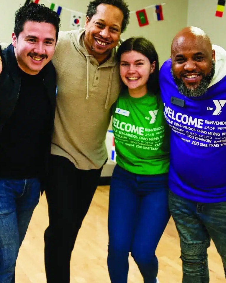 group of people standing arm in arm
