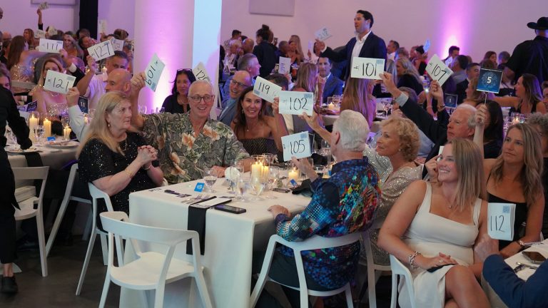 guests at the gala bidding on items