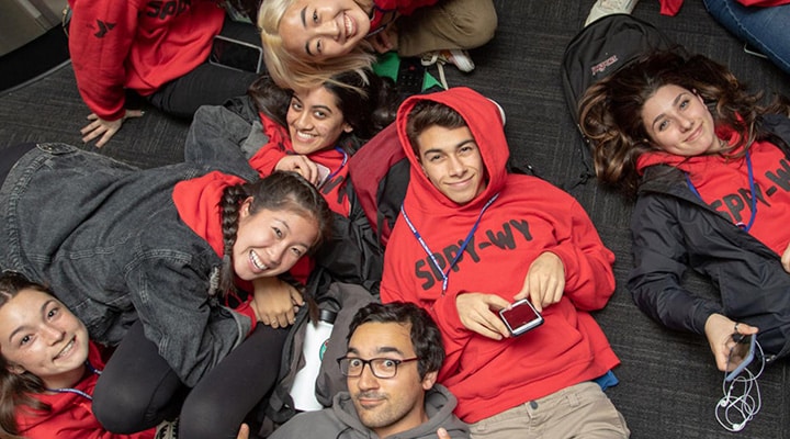teens in a group smiling